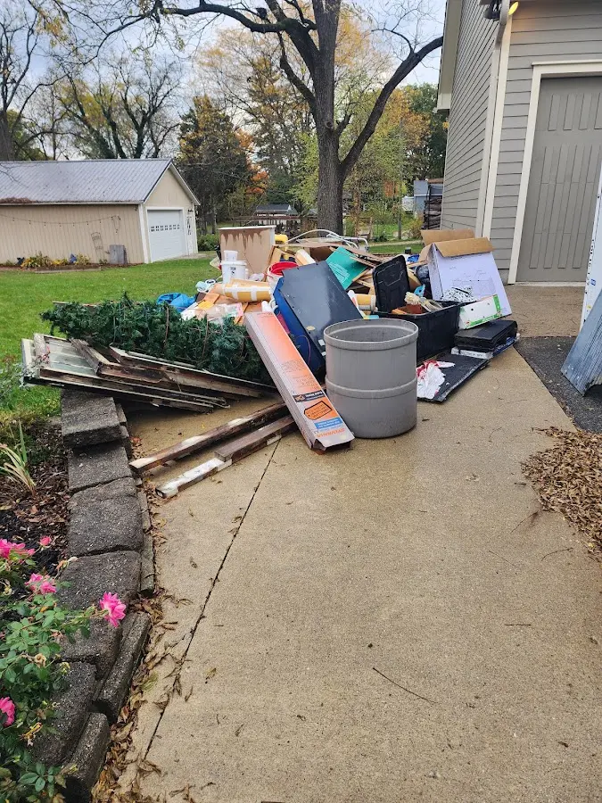 Dumpster being loaded with debris for 12 Yard Dumpster Rental in Orland